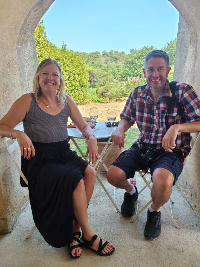 Alison and Dave sitting together in an arched doorway